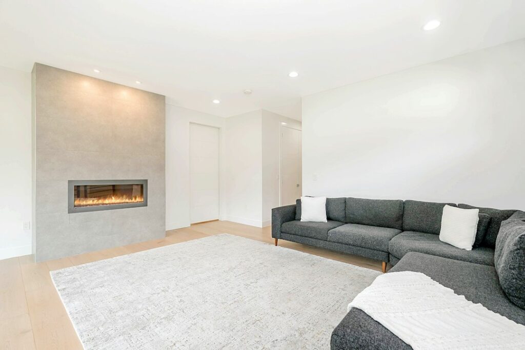 Spacious finished basement family room with seating and natural light