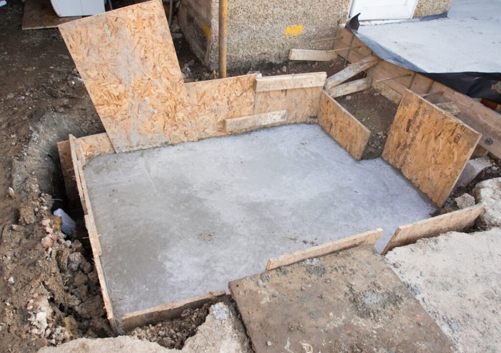 Exposed concrete foundation during a home construction project