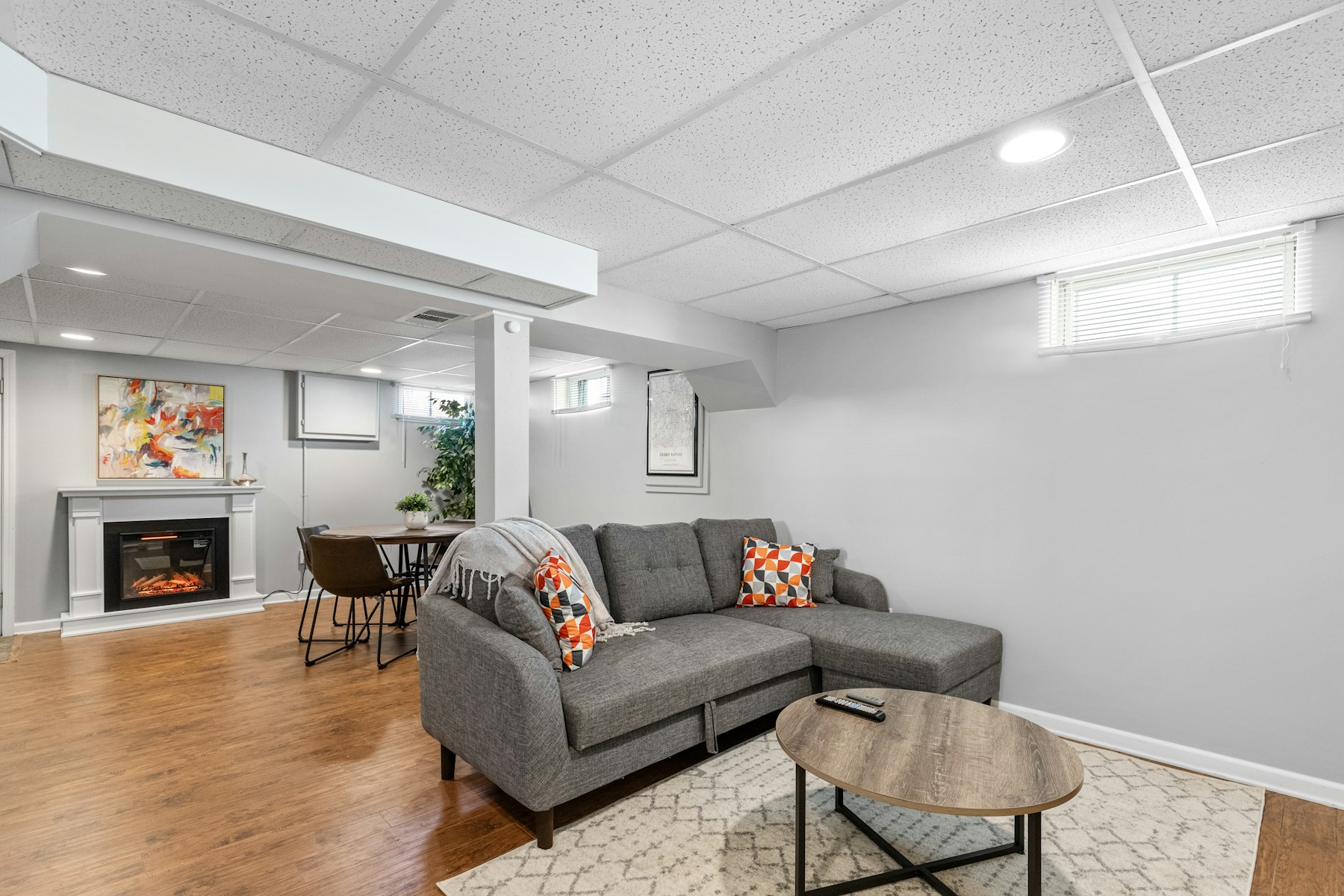 Bright finished basement family room with fireplace
